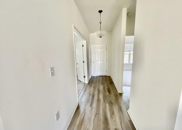 hallway with light hardwood / wood-style floors