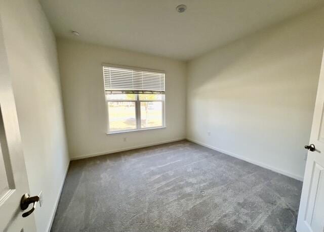 empty room featuring dark carpet