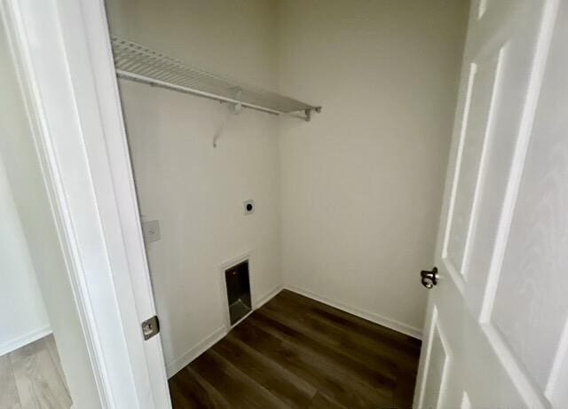 washroom featuring dark wood-type flooring and hookup for an electric dryer