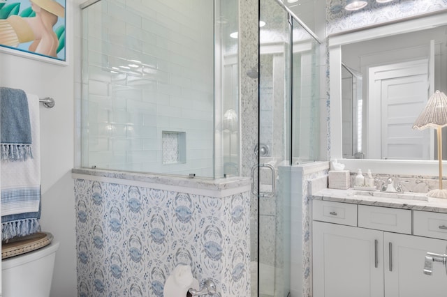 bathroom with vanity, toilet, and an enclosed shower