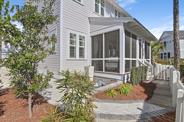 view of home's exterior featuring a sunroom