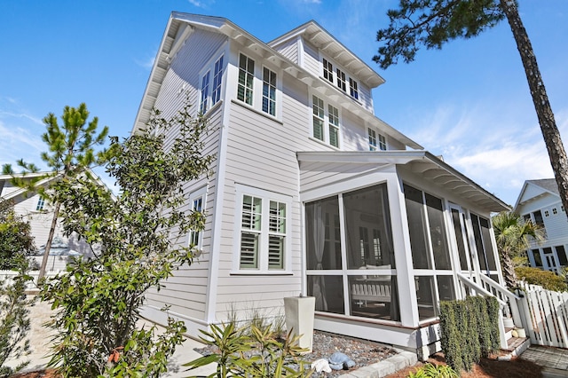 view of side of home featuring a sunroom