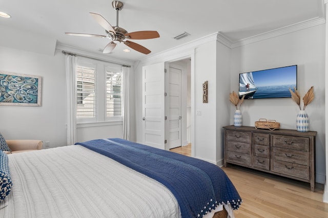 bedroom featuring crown molding, ceiling fan, and light wood-type flooring