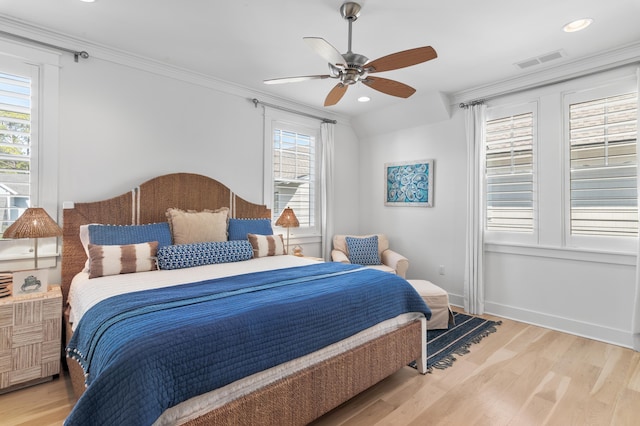 bedroom with ceiling fan, ornamental molding, and hardwood / wood-style floors