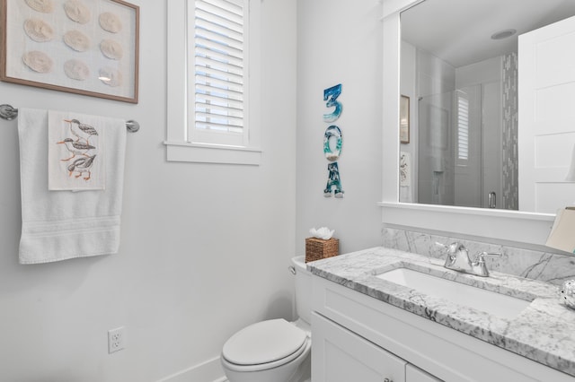 bathroom featuring walk in shower, vanity, and toilet