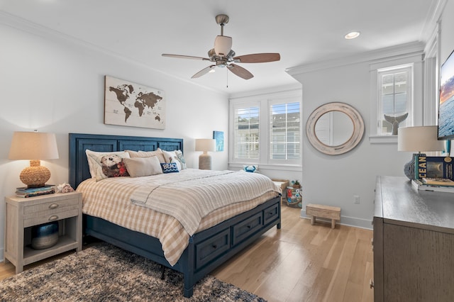 bedroom featuring crown molding, light hardwood / wood-style flooring, and ceiling fan