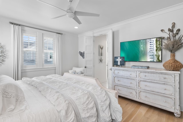 bedroom with crown molding, ceiling fan, and light wood-type flooring