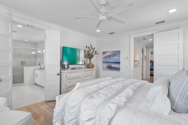 bedroom featuring crown molding, ensuite bath, ceiling fan, and light wood-type flooring