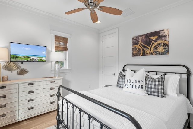 bedroom featuring crown molding, ceiling fan, and light hardwood / wood-style flooring