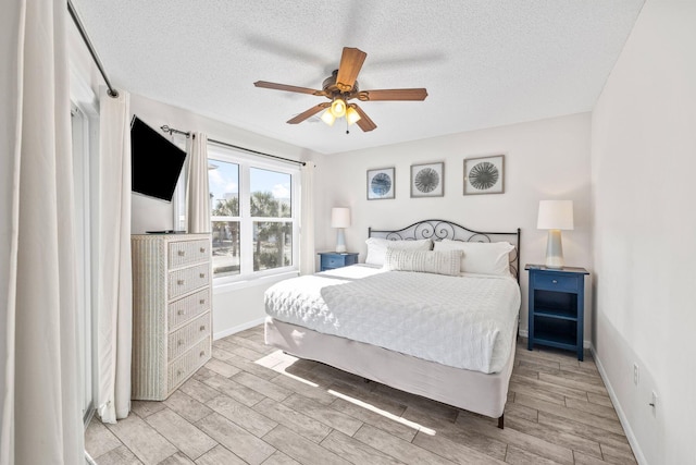 bedroom featuring ceiling fan and a textured ceiling