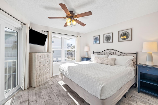 bedroom with ceiling fan and a textured ceiling