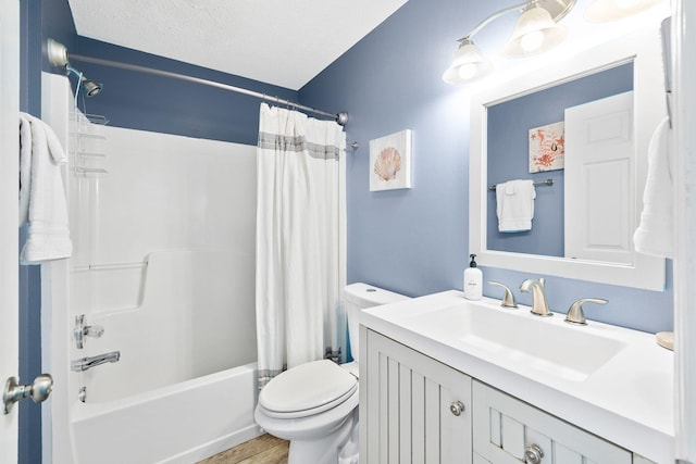 full bathroom with shower / bath combo, vanity, wood-type flooring, a textured ceiling, and toilet