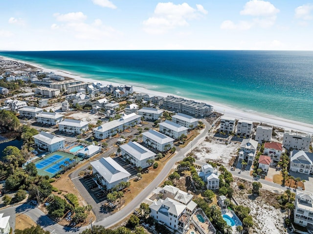 drone / aerial view with a water view and a beach view