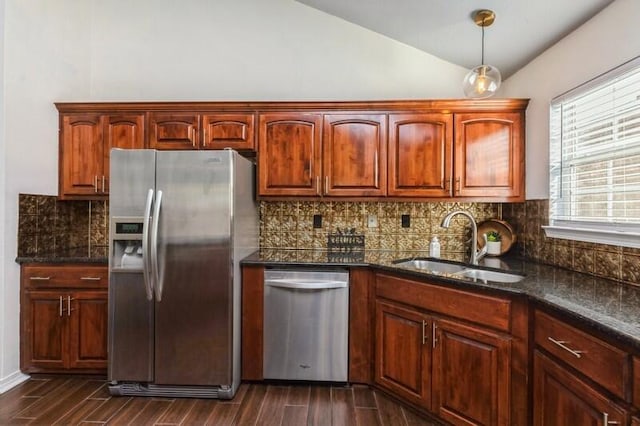 kitchen featuring appliances with stainless steel finishes, dark hardwood / wood-style floors, lofted ceiling, sink, and backsplash