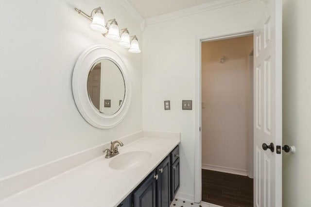 bathroom with ornamental molding, hardwood / wood-style floors, and vanity