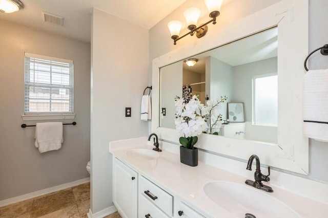 bathroom with vanity, tile patterned floors, and toilet