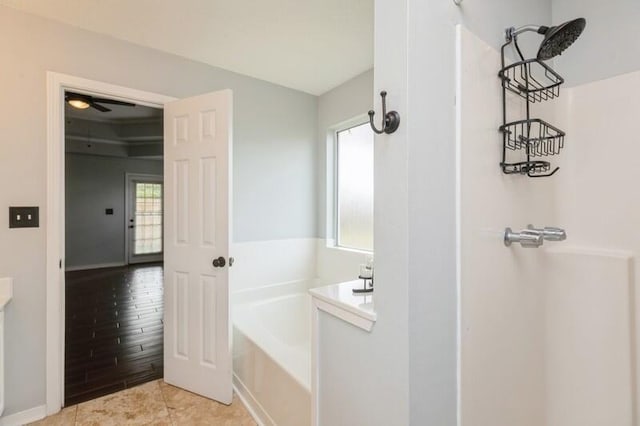 bathroom with tile patterned flooring and a washtub