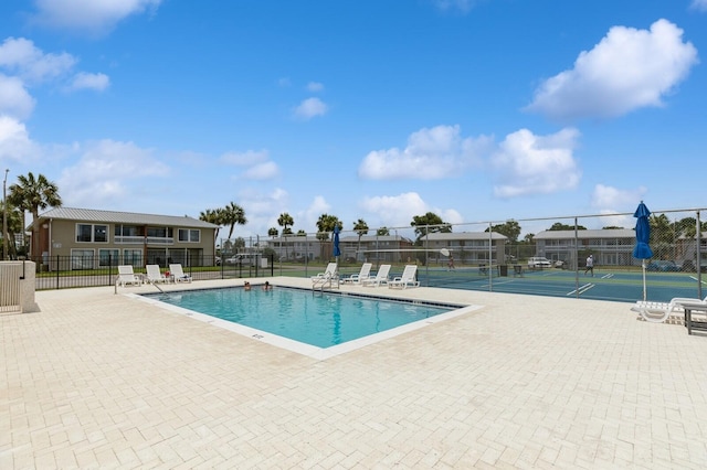 view of pool featuring tennis court