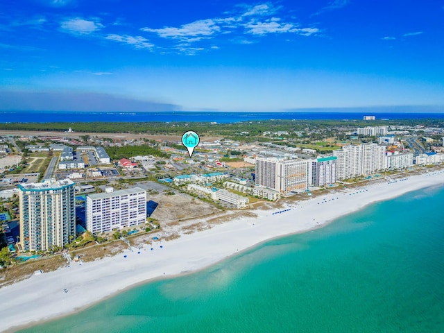 aerial view with a water view and a beach view