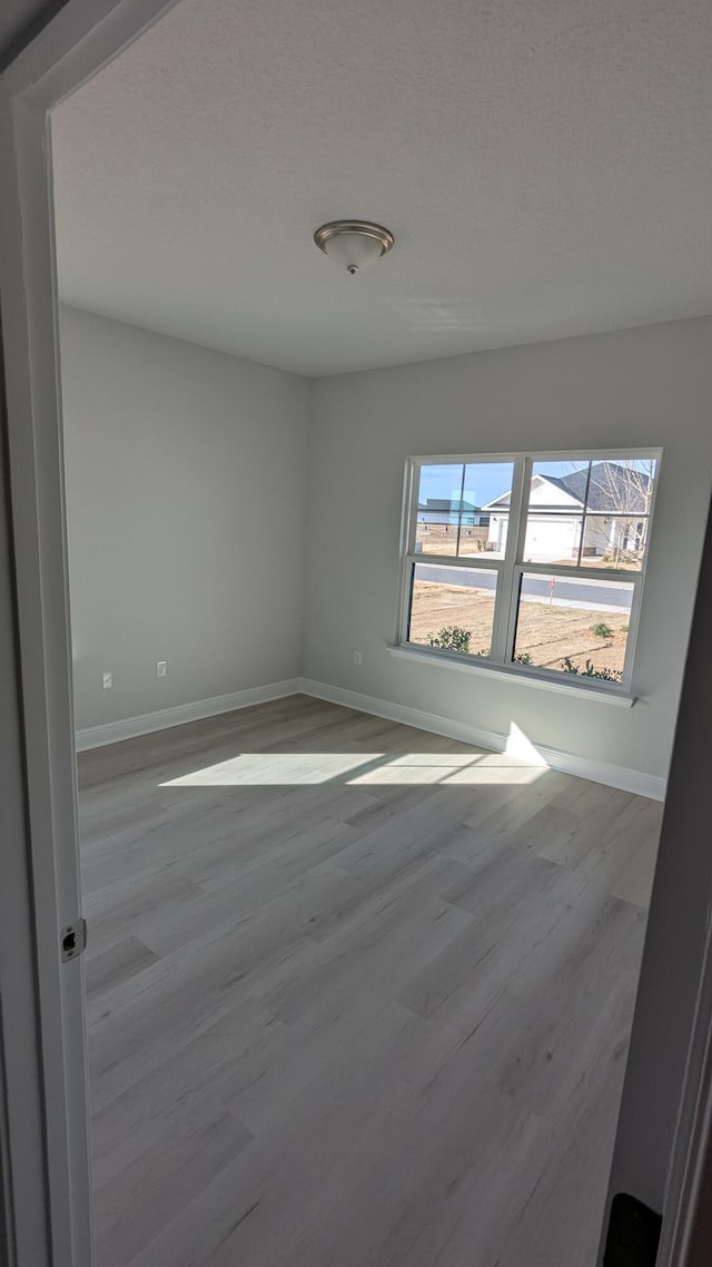 unfurnished room featuring light hardwood / wood-style flooring