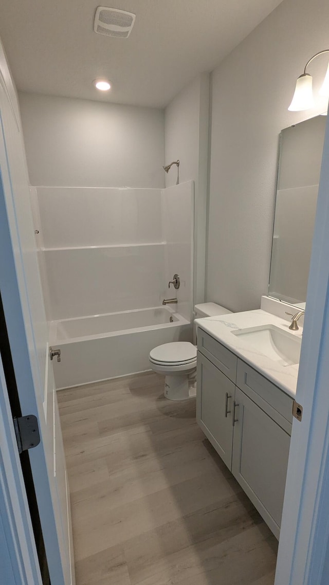 full bathroom with vanity, toilet, shower / bathing tub combination, and wood-type flooring