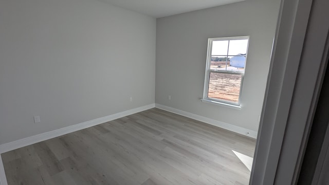 spare room with light hardwood / wood-style flooring