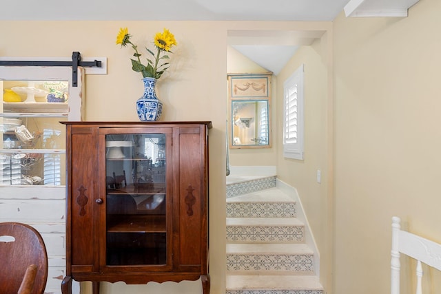 stairs featuring a barn door