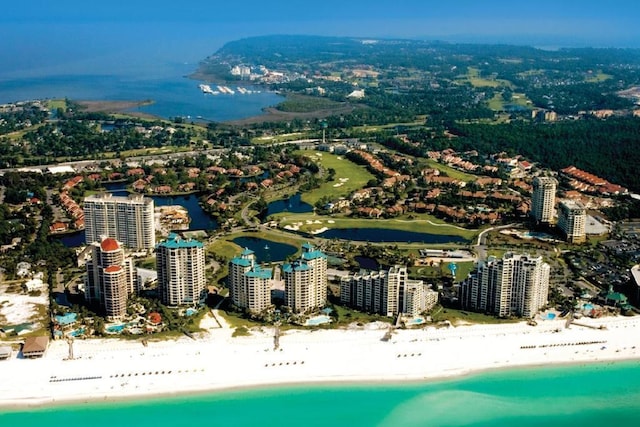 drone / aerial view featuring a water view and a beach view