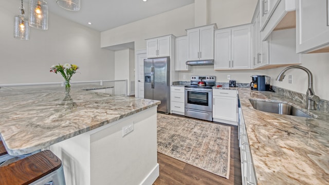 kitchen with light stone counters, sink, white cabinets, and appliances with stainless steel finishes