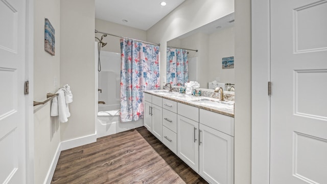 bathroom featuring wood-type flooring, shower / tub combo with curtain, and vanity