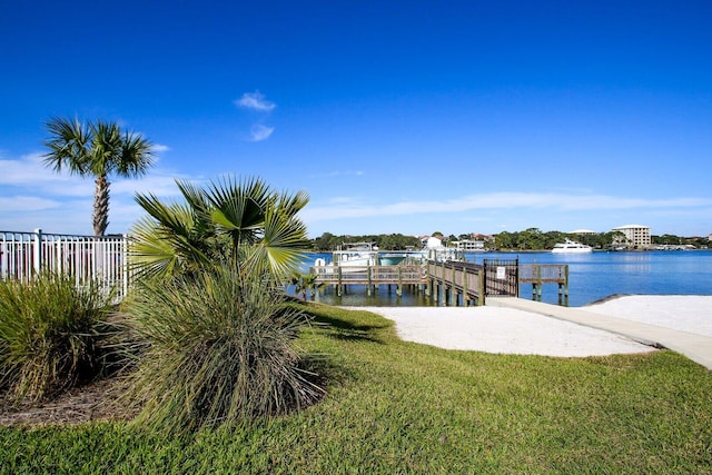 view of dock featuring a water view and a lawn