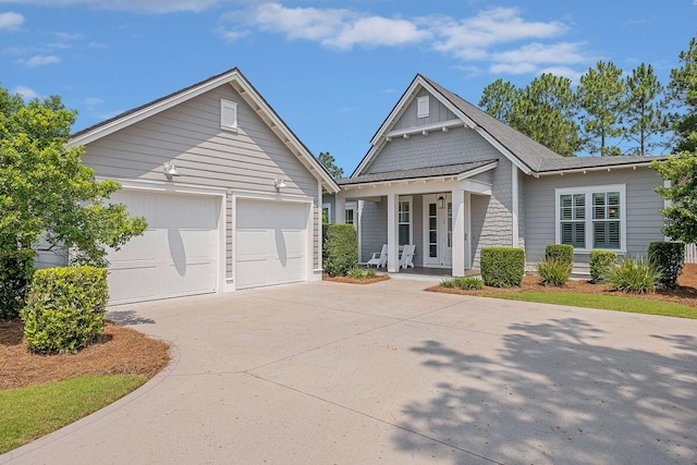 view of front of home featuring a porch and a garage