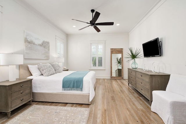 bedroom with crown molding, light hardwood / wood-style floors, and ceiling fan