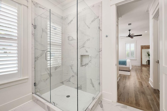 bathroom featuring ceiling fan and walk in shower