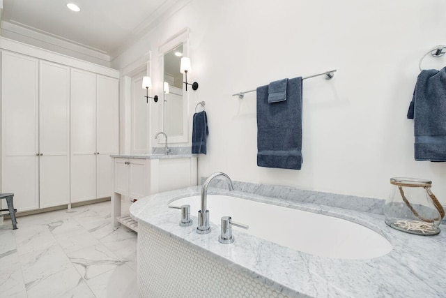 bathroom featuring vanity and a washtub