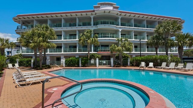 view of pool with a hot tub