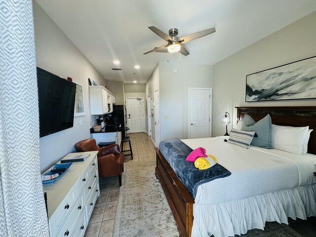 tiled bedroom with ceiling fan