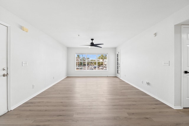 unfurnished living room with hardwood / wood-style floors and ceiling fan