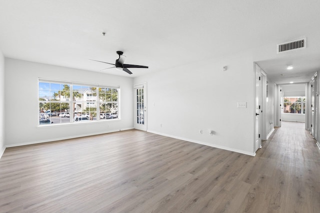 empty room with hardwood / wood-style flooring and ceiling fan