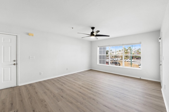 spare room featuring hardwood / wood-style flooring and ceiling fan