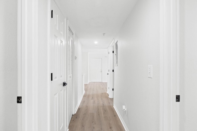 corridor with light hardwood / wood-style flooring