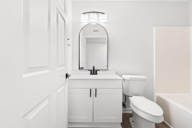 full bathroom featuring vanity, hardwood / wood-style floors, shower / bathing tub combination, and toilet