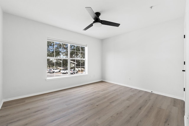 spare room with ceiling fan and light wood-type flooring