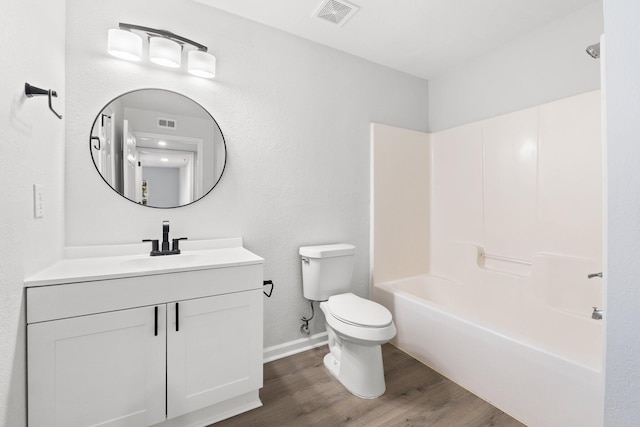 full bathroom with vanity, hardwood / wood-style floors, shower / washtub combination, and toilet