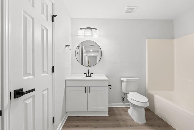 full bathroom with vanity, shower / bathing tub combination, hardwood / wood-style flooring, and toilet