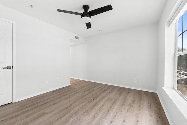 empty room with light hardwood / wood-style flooring and ceiling fan