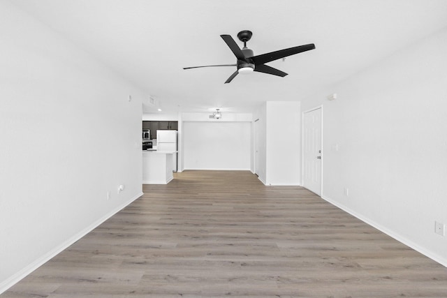 interior space with wood-type flooring and ceiling fan