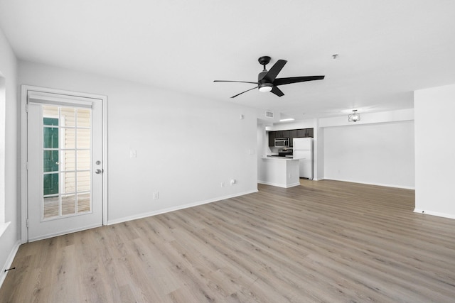 unfurnished living room featuring light wood-type flooring and ceiling fan