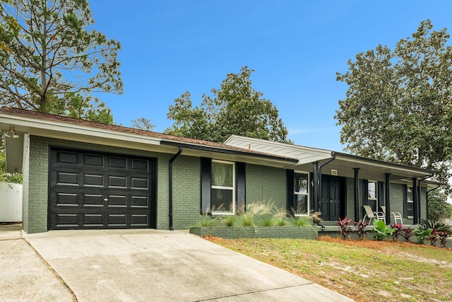 ranch-style home with a garage and a front yard