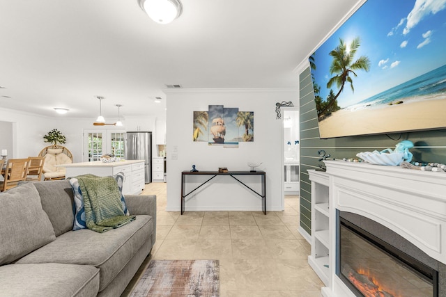 living room featuring light tile patterned floors and ornamental molding